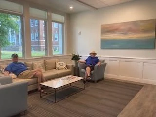 Patrons relaxing in the lobby by large windows