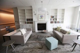Lounge seating by the fireplace and bookshelves
