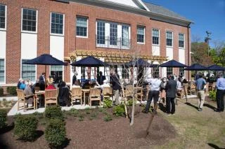 Guests gathered on the patio at the ribbon cutting